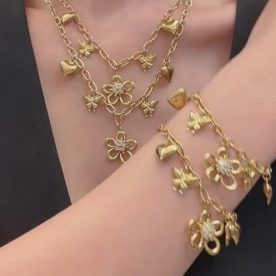 Video showcasing 316L stainless steel floral butterfly charm necklace and matching bracelet in an 18K PVD gold finish with zircon flower and heart details