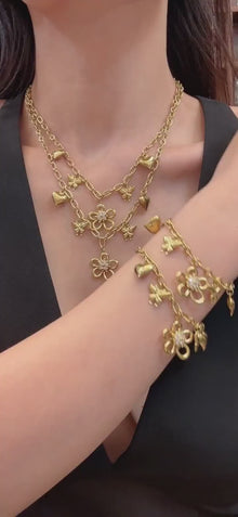 Video showcasing 316L stainless steel floral butterfly charm necklace and matching bracelet in an 18K PVD gold finish with zircon flower and heart details