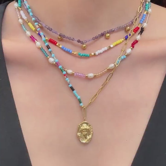 Video showing multicolor natural stone and freshwater pearl beaded necklace in 316L stainless steel for summer boutique resort styling