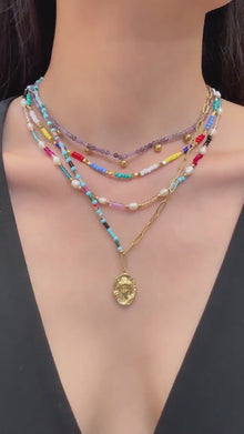 Video showing multicolor natural stone and freshwater pearl beaded necklace in 316L stainless steel for summer boutique resort styling
