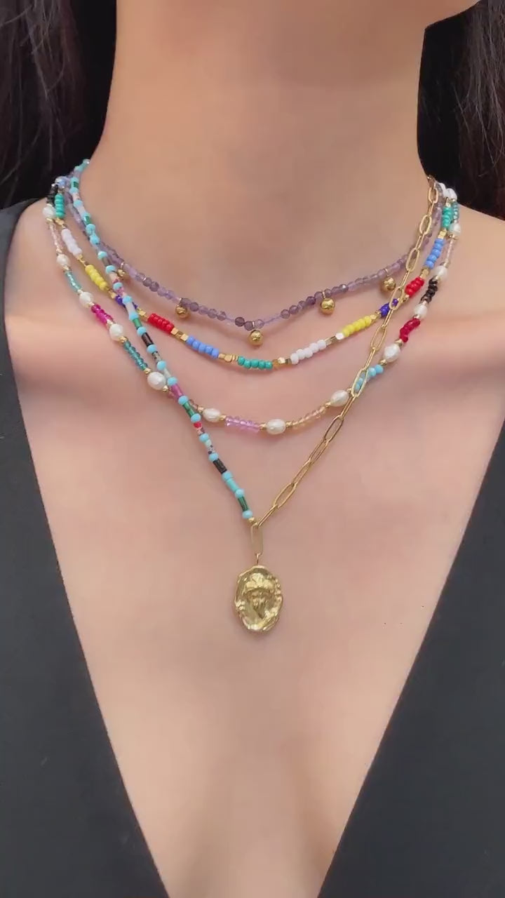 Video showing multicolor natural stone and freshwater pearl beaded necklace in 316L stainless steel for summer boutique resort styling