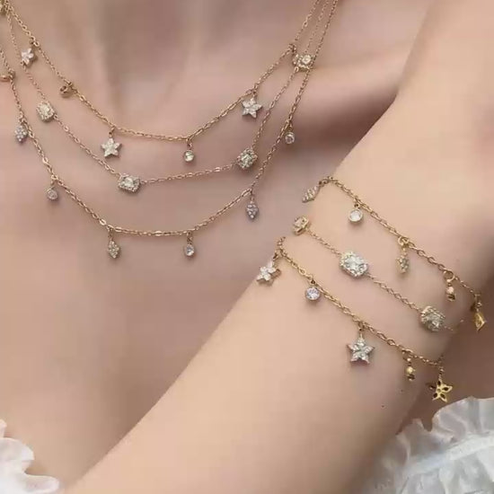 Video cover of model wearing gold zircon charm necklace and bracelet collection with square, diamond and flower pendants in 316L stainless steel by Miduoduo Jewelry