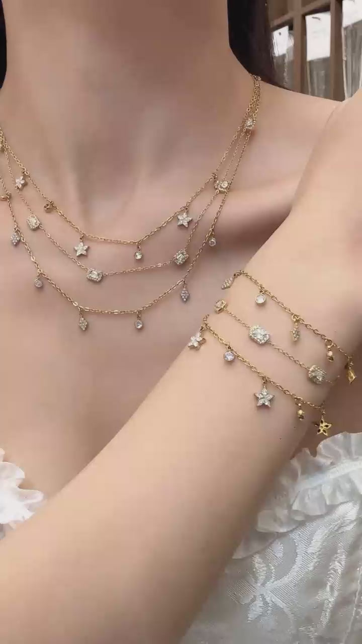 Video cover of model wearing gold zircon charm necklace and bracelet collection with square, diamond and flower pendants in 316L stainless steel by Miduoduo Jewelry