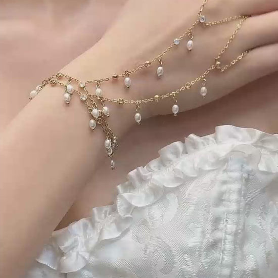 Video cover showing model wearing gold zircon pearl finger chain bracelet hand chain in 316L stainless steel elegant women jewelry by Miduoduo Jewelry