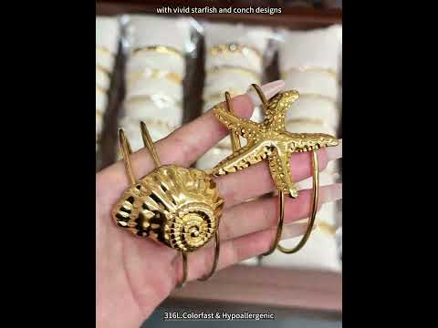 Video showing 18K PVD gold ocean starfish shell open bangle made with 316L stainless steel for beach and resort jewelry wholesale buyers