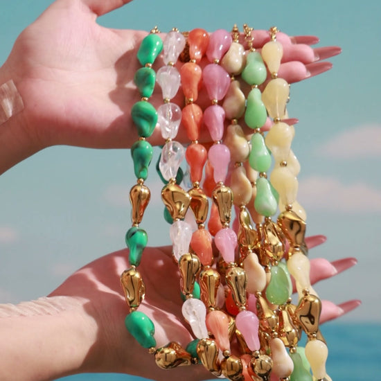 Styling video showcasing colorful chunky resin necklaces and matching bracelets with organic statement shapes