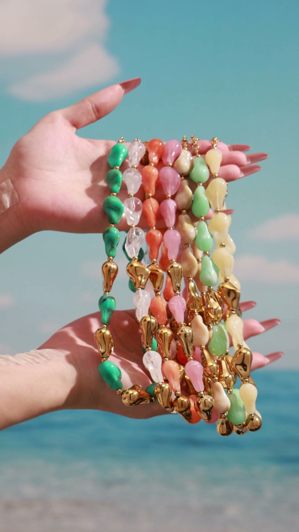 Styling video showcasing colorful chunky resin necklaces and matching bracelets with organic statement shapes