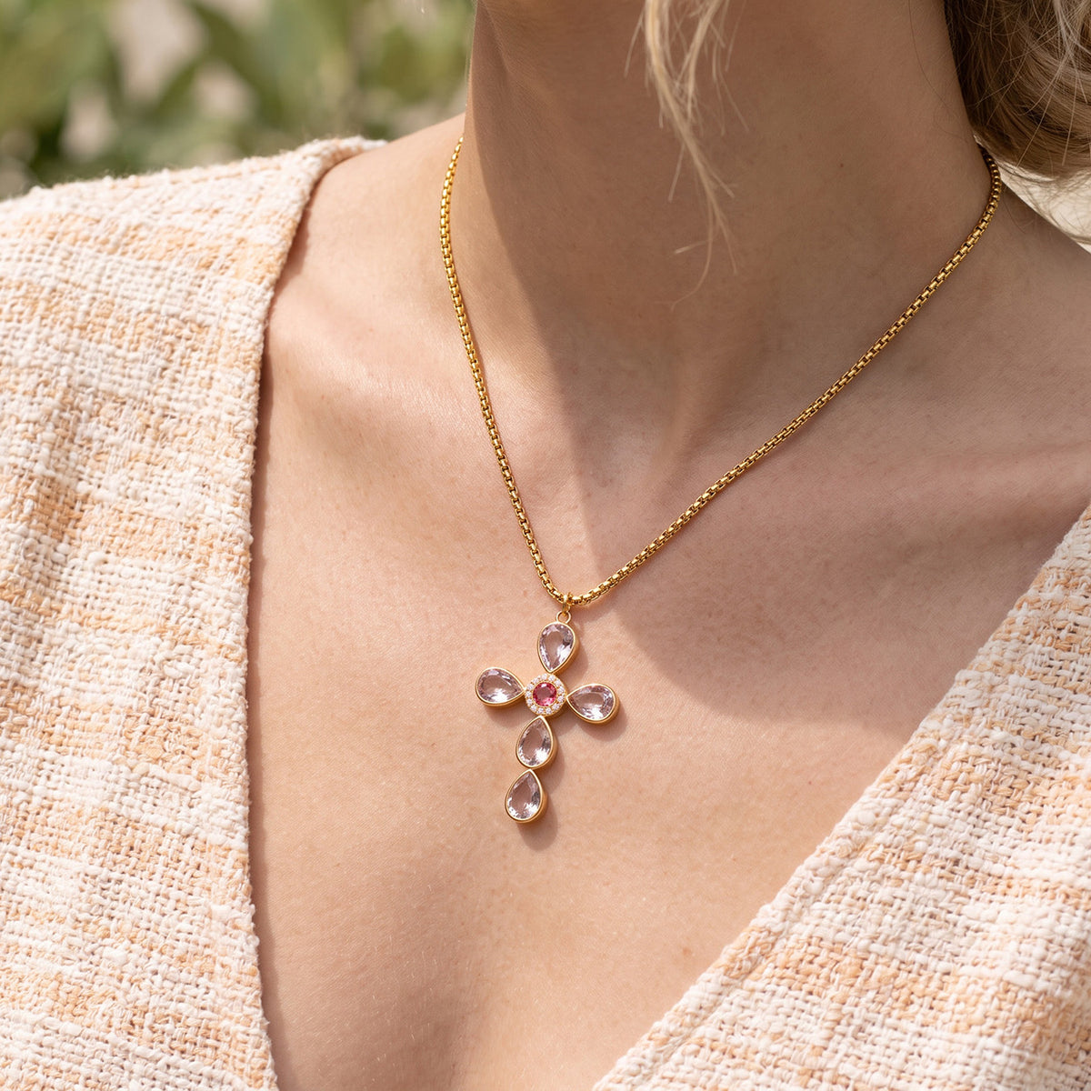 Purple stone-set cross necklace styled on model