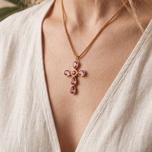 Purple stone cross necklace worn on model
