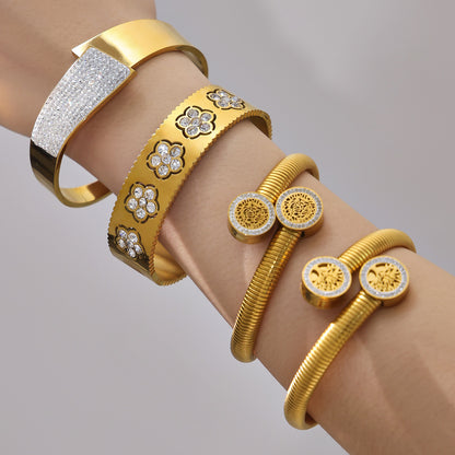 Closeup of PVD gold plated zircon flower open bangle set on wrist: fade-resistant PVD finish