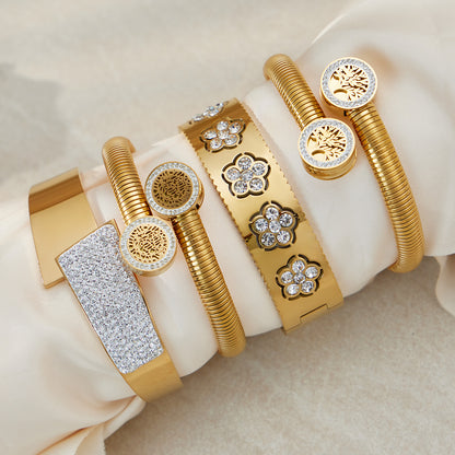 PVD gold plated zircon flower open bangle set styled on fabric: elegant lightweight design