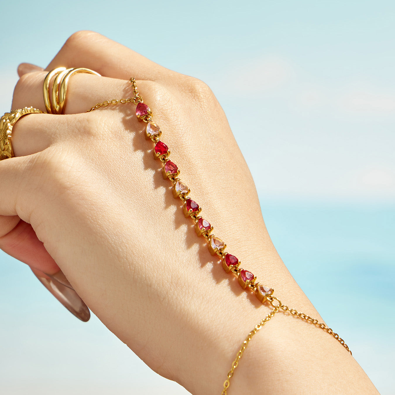 Red stone wrist-to-finger bracelet with colorful zircon chain details