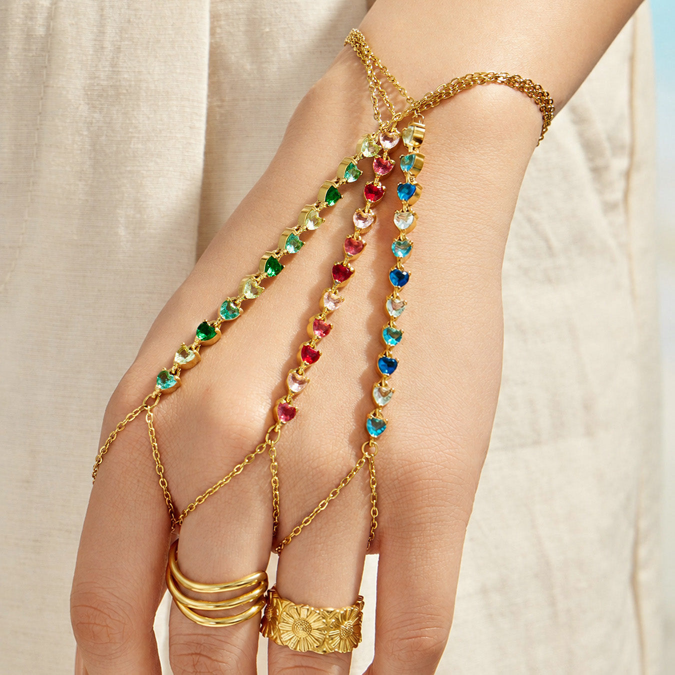 Red cubic zirconia hand chain bracelet with 18K PVD gold finish