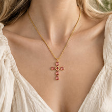 Red faceted stone cross pendant necklace worn on model