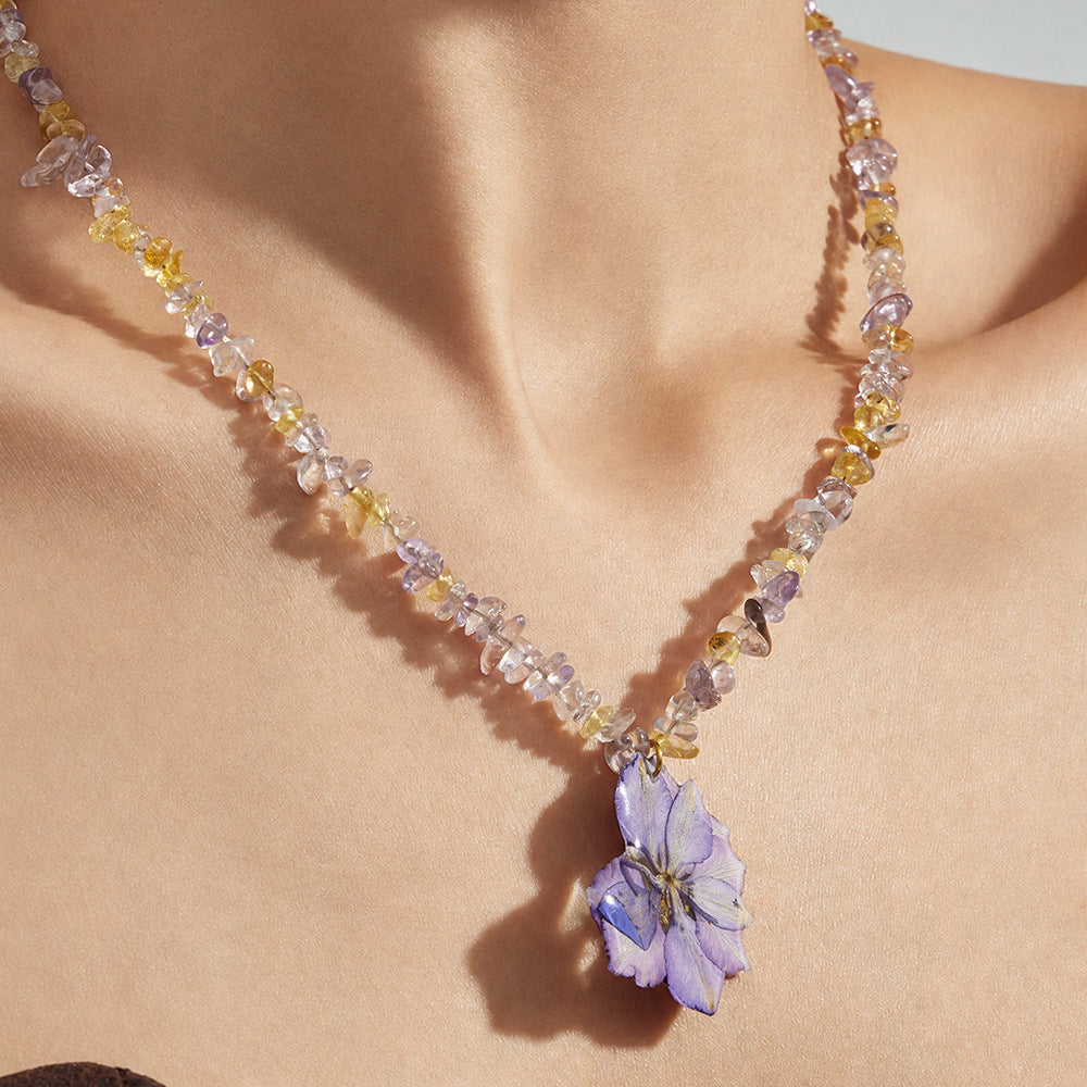 Close-up of model wearing purple resin flower necklace with crystal beads for summer gift jewelry