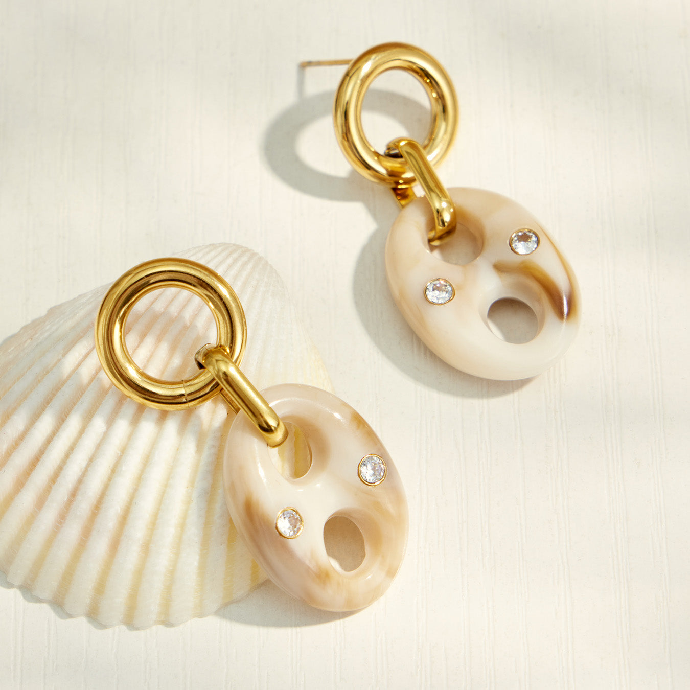 Pair of cream resin mariner link drop earrings with polished gold-tone details