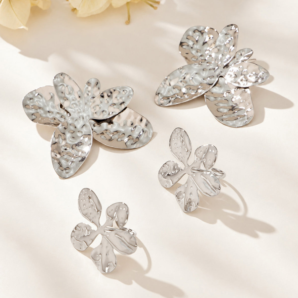 Steel-tone hammered flower earrings and matching ring collection in stainless steel