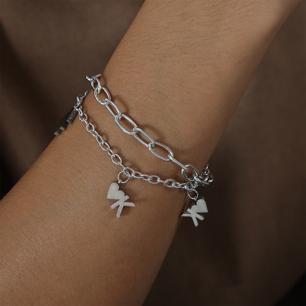 Silver heart chain bracelet displayed on dark background for unisex street-style jewelry and boutique collections