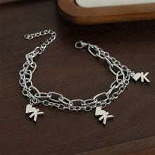 Silver heart chain bracelet displayed on dark background for unisex street-style jewelry and boutique collections