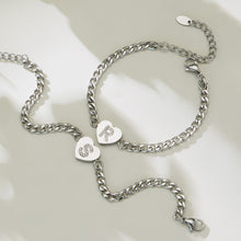 Silver-tone zircon initial heart necklace and bracelet matching set displayed on a neutral background