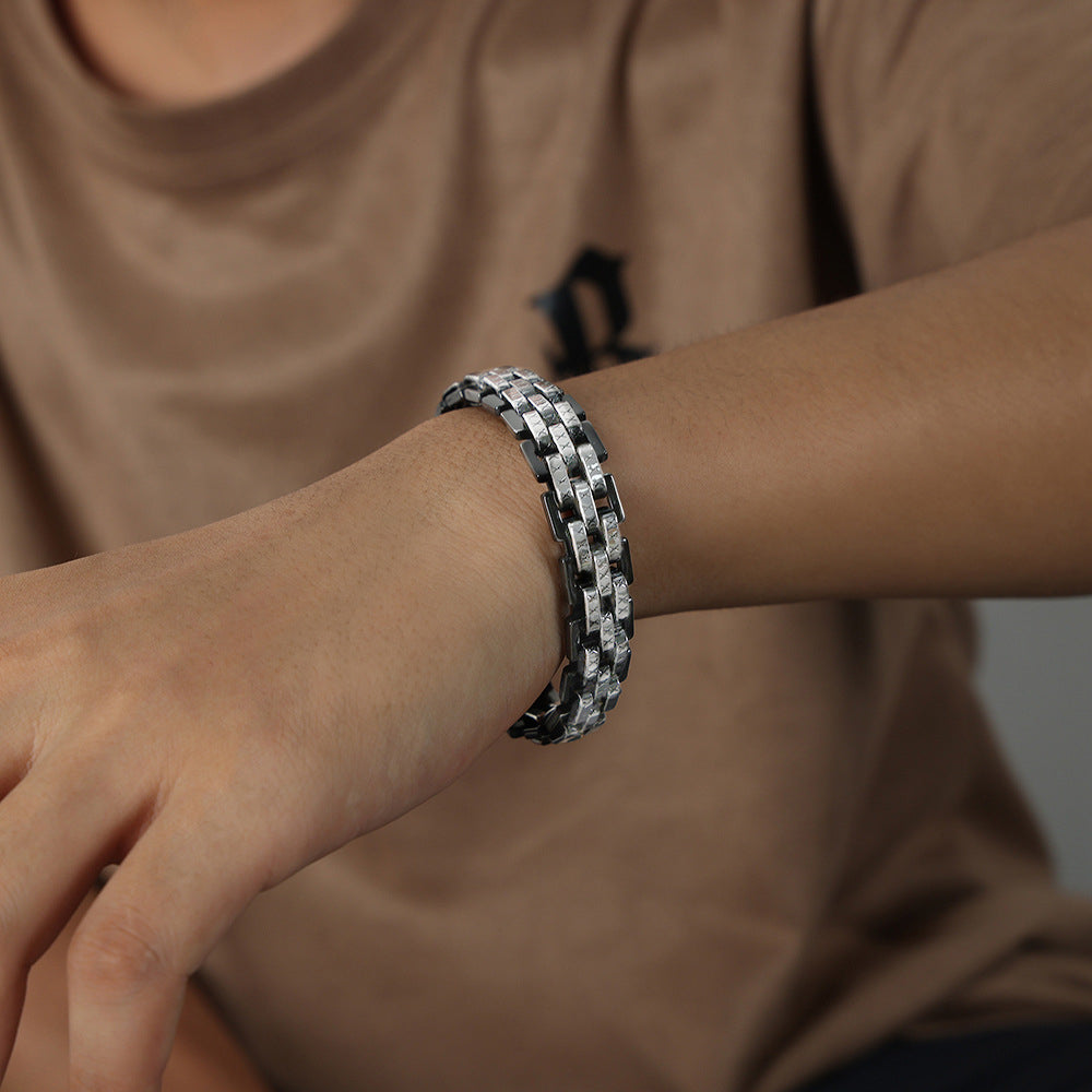 Silver and black 316L stainless steel lobster clasp bracelet on male wrist, durable and stylish, waterproof and streetwear fashion accessory
