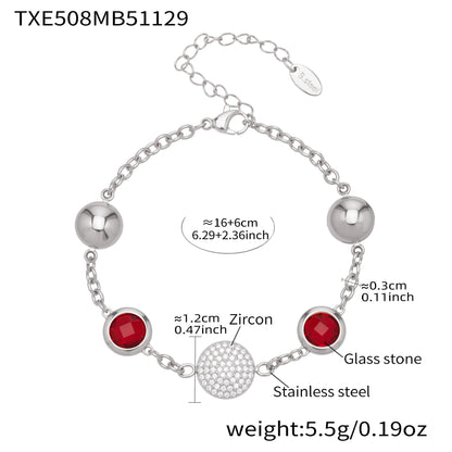 Silver tone stainless steel charm bracelet with red glass stones and zircon centerpiece