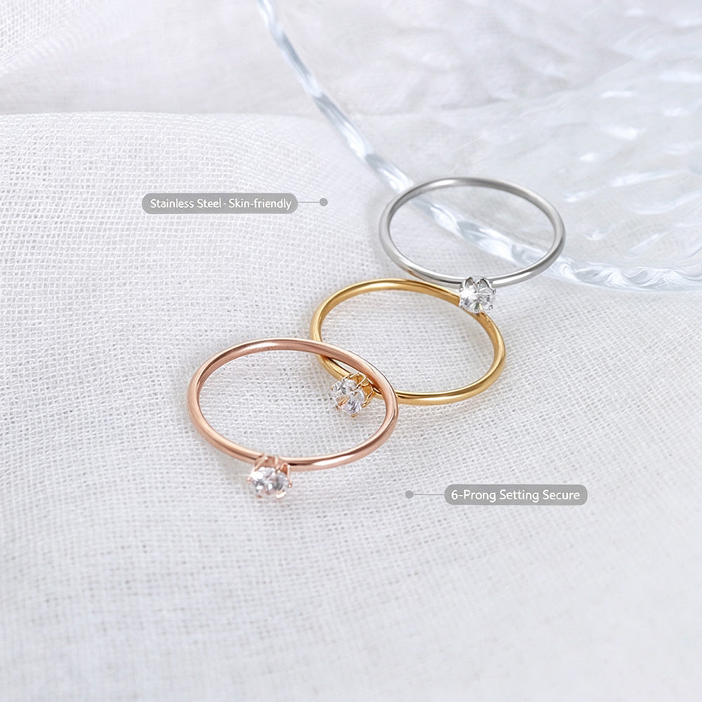 Gold and silver tone minimalist solitaire stacking rings with single round clear stone detail