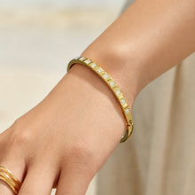 Model wearing a slim gold zircon bangle bracelet on the wrist
