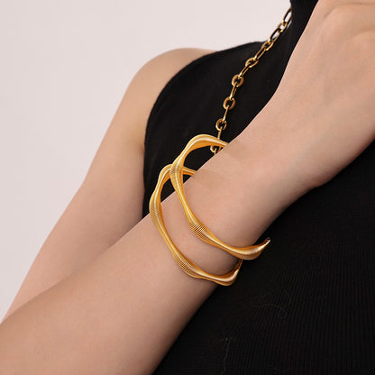 gold spiral texture bangle, model wearing with necklace