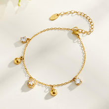 Gold tone stainless steel square zircon bracelet flat lay