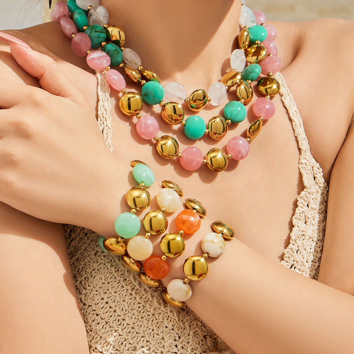 Lifestyle close-up of stacked colorful resin bracelets worn together for a boutique summer jewelry style.