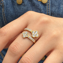 A456 gold-tone double-flower open ring worn on a finger, showing two four-petal motifs
