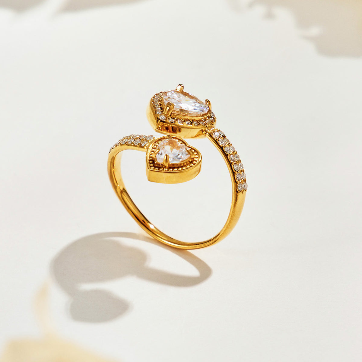 Side view of the A459 gold-tone double-heart halo ring showing raised heart-shaped stones