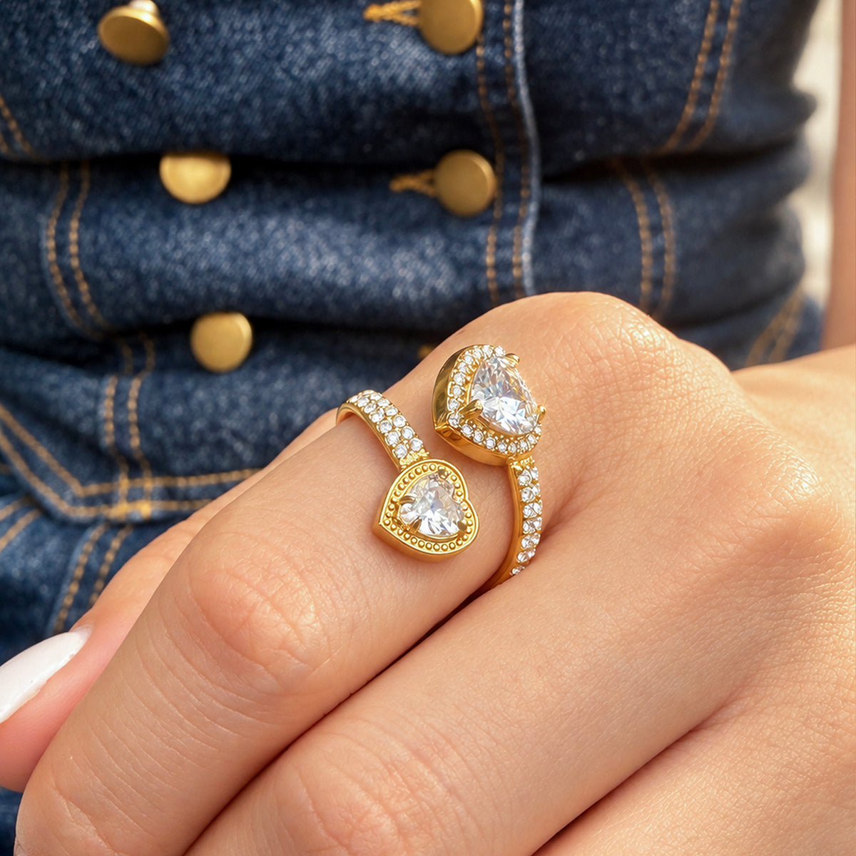 A459 gold-tone double-heart halo open ring worn on a finger, showing two clear heart-shaped center stones