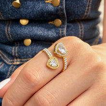 A459 gold-tone double-heart halo open ring worn on a finger, showing two clear heart-shaped center stones