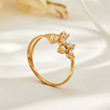 Side view of the A471 gold-tone flower open ring, showing its raised stone settings