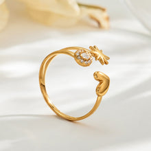 Side view of the A479 gold-tone heart and star open ring with a round clear-stone accent