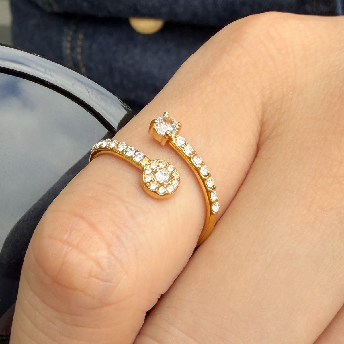 A639 gold-tone open ring worn on a finger, featuring a round decorative stone detail