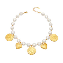 Stainless steel beaded heart charm necklace with ivory-tone beads and gold medallion details