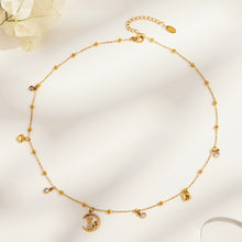 Gold-tone stainless steel cat moon necklace arranged in a circle, with heart charms and clear stone accents
