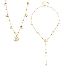 Gold-tone stainless steel cat moon pendant necklace beside an ornamental Y lariat necklace with beaded chain details