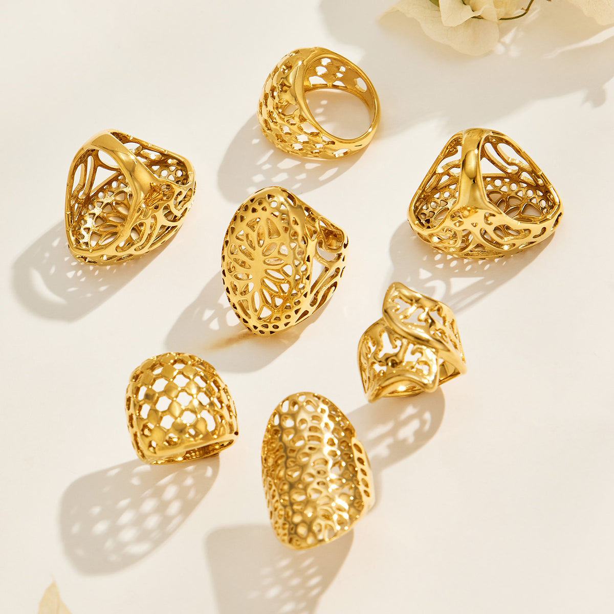 Gold-tone stainless steel cutout rings arranged in multiple positions to show their decorative faces and bands