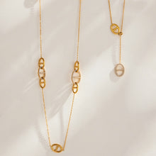 Gold plated stainless steel geometric link necklaces displayed in layered arrangements