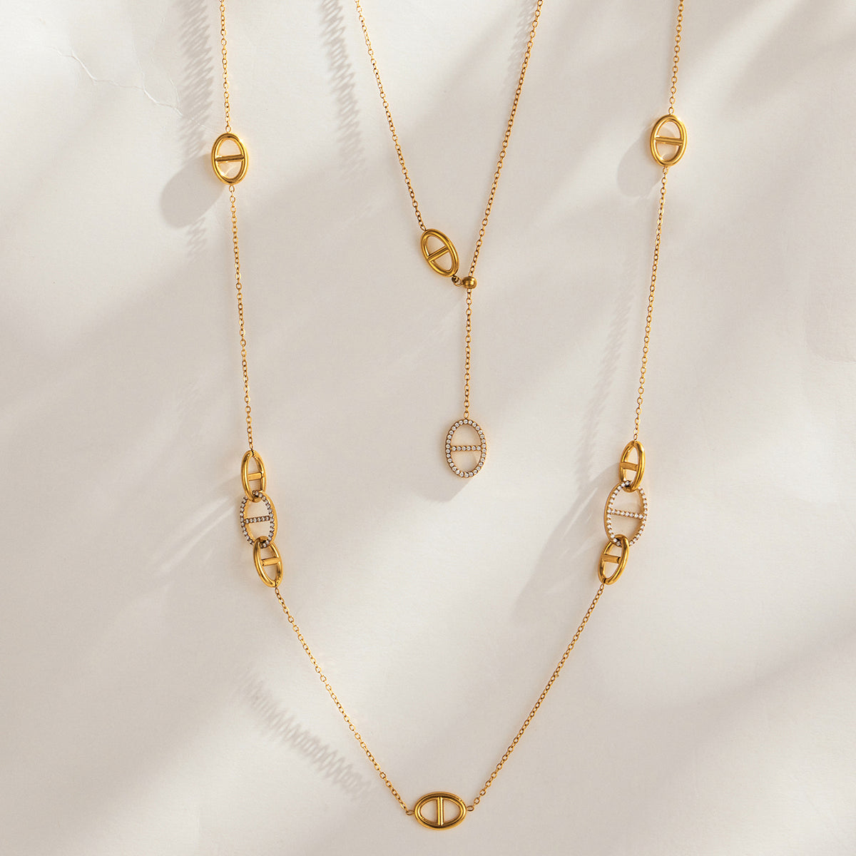Gold-tone stainless steel geometric link Y necklace with circular link and drop pendant details