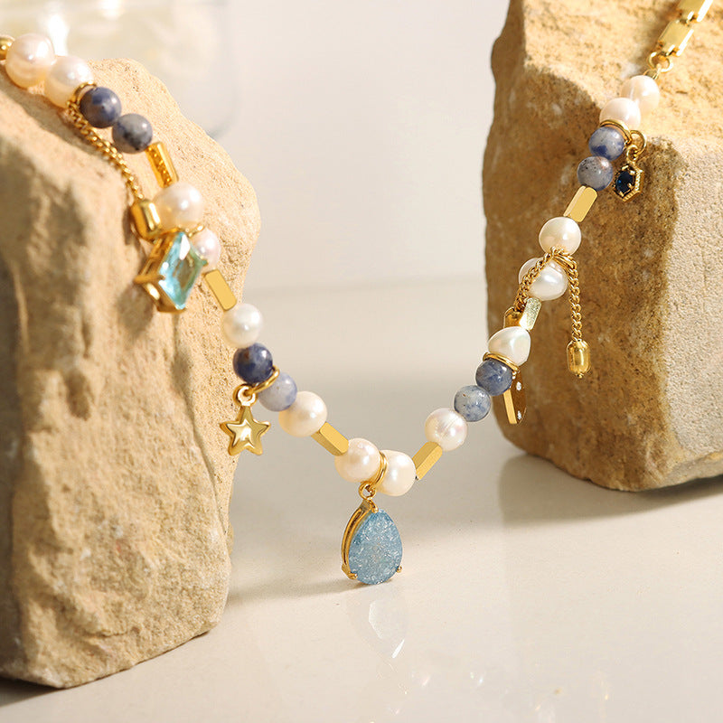 Natural stone and pearl details on stainless steel charm necklace
