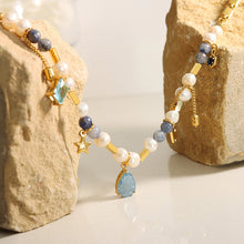 Natural stone and pearl details on stainless steel charm necklace