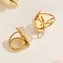 Gold-tone stainless steel open-band construction on resin statement rings