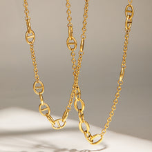 Stainless steel oval link necklaces with gold plated finish displayed hanging