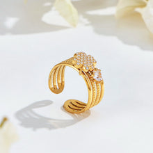 Gold-tone stainless steel open ring with a pavé leaf motif, clear stone accent and layered bands