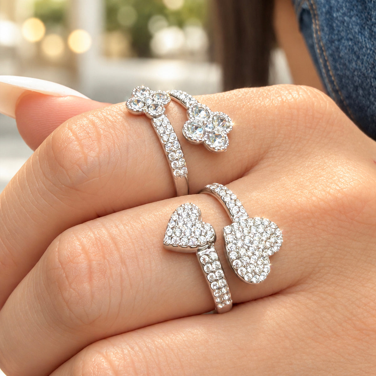 Steel-tone stainless steel double-flower and pave-heart open rings worn side by side